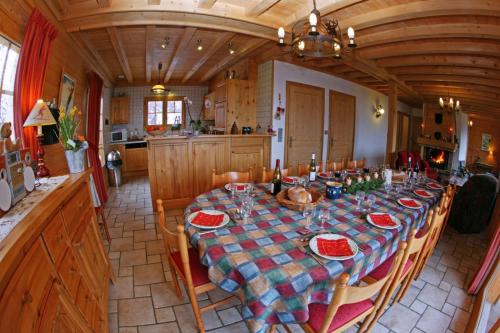 a dining room with a table in a kitchen at Chalet Le Sabot De Venus in Combloux