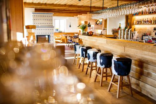 a bar with a row of stools in a restaurant at Chata Hradečanka in Horní Malá Úpa