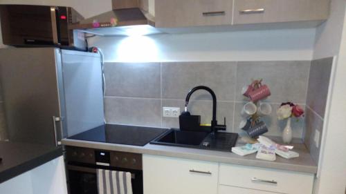 a kitchen with a sink and a refrigerator at Apartment Kornwestheim in Kornwestheim