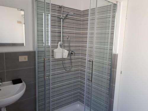a bathroom with a glass shower with a sink at Villa Donati in Cesenatico