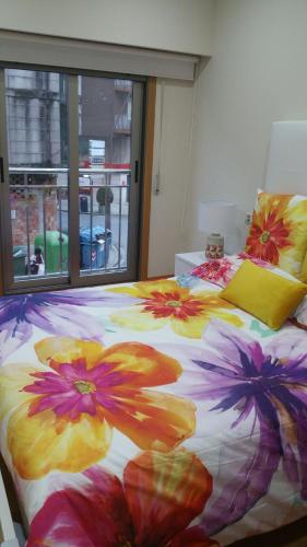 a bedroom with two beds with flowers on them at Apartamento Centro Porriño in Porriño