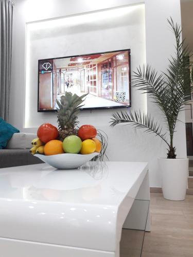 a bowl of fruit on a table in a living room at Abbazia Apartments Free Parking Near Center and Vrbas River in Banja Luka