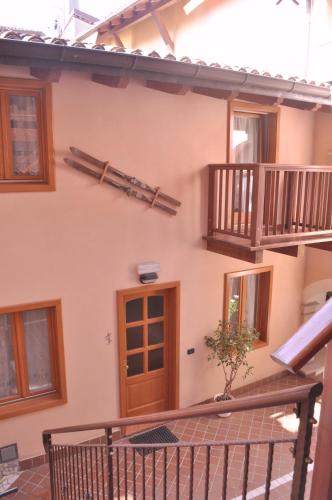 a house with a wooden door and a balcony at Ai Vellutai in Ala