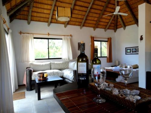 a living room with two bottles of wine on a table at Aloha Village in La Pedrera
