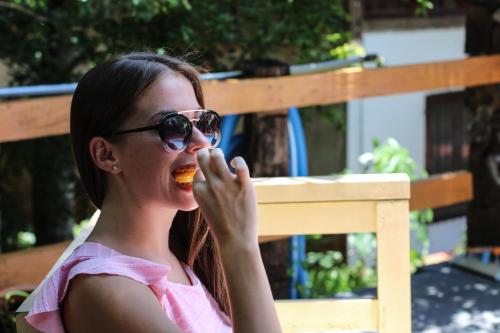 a young woman eating a piece of food at Palo Rosa Lodge in Puerto Iguazú