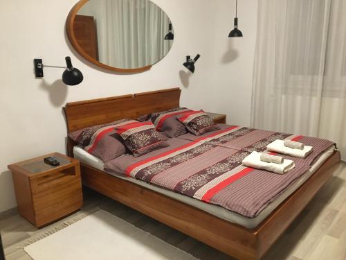 una camera da letto con un letto con uno specchio sul muro di Heroes' Residence a Budapest