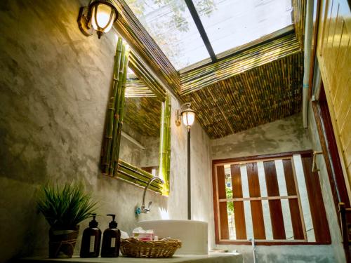 a bathroom with a sink and a window at Rapala Rock Wood Resort- SHA Plus in Railay Beach