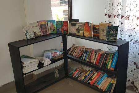 two book shelves filled with books in a room at Rohan's Residence in Kandana