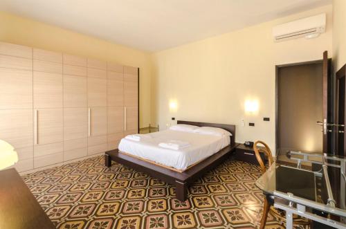 a hotel room with a bed and a bathroom at Piazza Maggiore Suite in Bologna