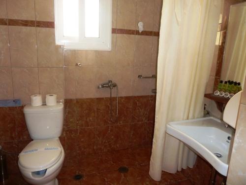 a bathroom with a toilet and a sink at Elafonisos Diamond Resort in Elafonisos
