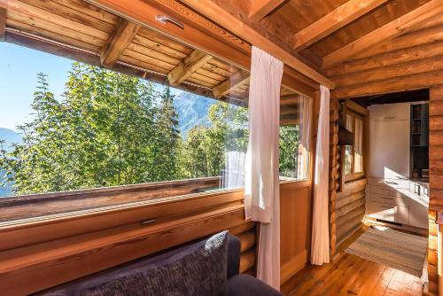 a view from the living room of a cabin with a large window at Ropferhof in Telfs-Buchen