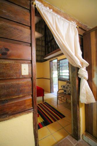 an open door to a room with a bunk bed at Cohune Palms River Cabanas in Bullet Tree Falls