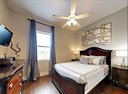 a bedroom with a bed and a ceiling fan at Beachfront Bliss in Galveston