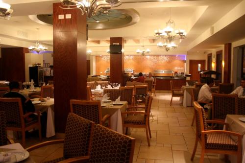 a restaurant with tables and people sitting at tables at Royal Palace in Hermosillo
