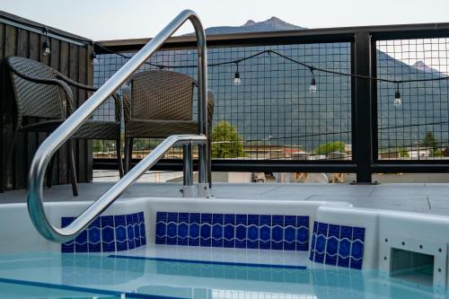 a swimming pool with a chair on a balcony at Eleven Revelstoke Lodge in Revelstoke