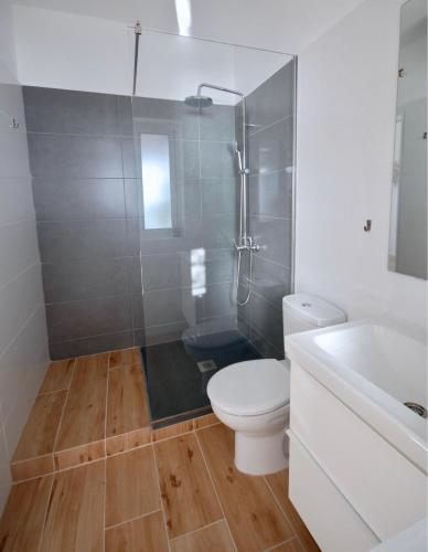 a bathroom with a toilet and a shower and a sink at Sea Lovers Jacuzzi Fuerteventura in Gran Tarajal