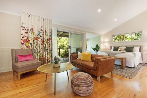 
a living room filled with furniture and flowers at Clouds Montville in Montville
