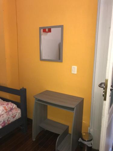 a room with a table and a mirror on the wall at Student’s Hostel in Montevideo