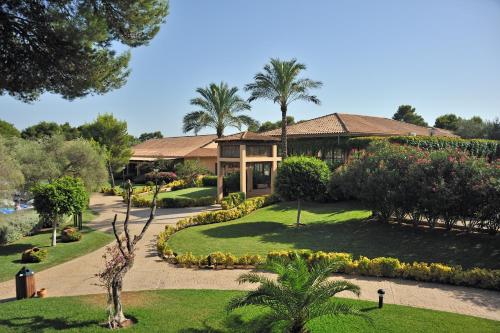 a house with a garden in front of it at Caprice Vell Mari Hotel & Resort - New Opening 2026 in Can Picafort