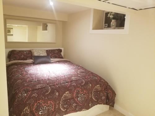a bedroom with a bed in the corner of a room at Your perfect stay away from home in Winnipeg