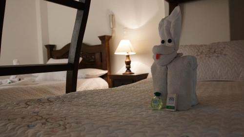 a stuffed bunny sitting on top of a bed at Hotel Sipa in Duitama