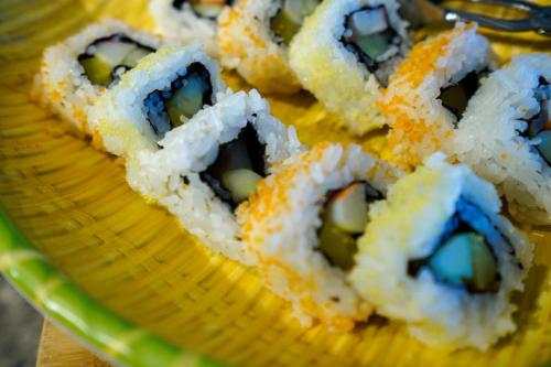 a basket filled with sushi on top of a table at Apartment Near Nanjing Road/ Jing'an Temple/ Renmin Plaza in Shanghai