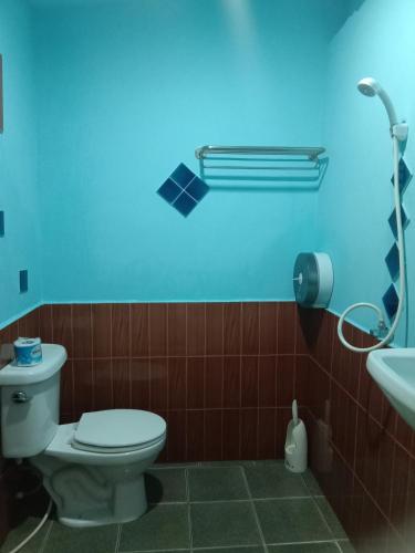 a bathroom with a white toilet and a sink at Sleep Whale Lanta in Ko Lanta