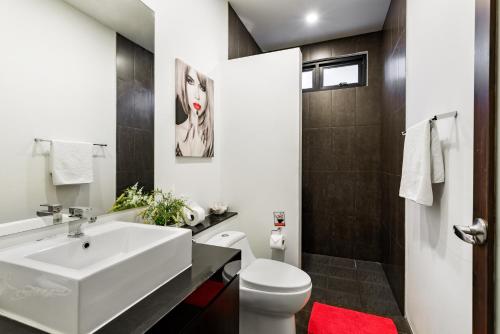 a bathroom with a white sink and a toilet at Big Buddha View 3br Pool Villa by Intira Villas in Rawai Beach