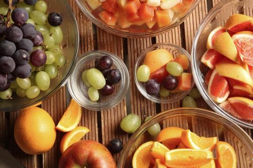 a bunch of bowls of fruit on a table at Karuizawakurabu Hotel 1130 Hewitt Resort in Tsumagoi