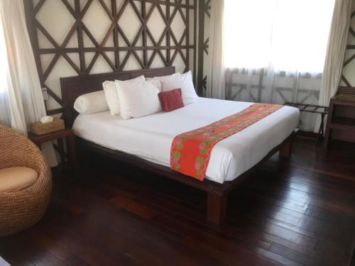 a bedroom with a large white bed with white pillows at ViewPoint Ecolodge in Nyaung Shwe