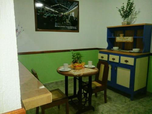 a kitchen with a small table and a small cabinet at Casa Palagui Colonial in Valladolid