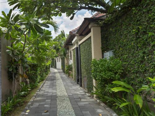 a walkway in front of a house at DISINI Luxury Spa Villas-CHSE Certified in Seminyak