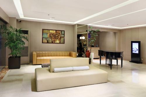 a living room with a couch and a table at City Garden Suites in Manila