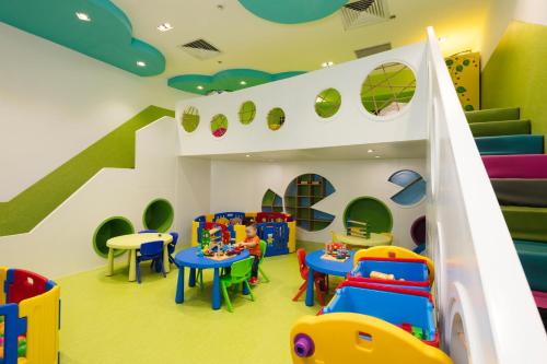a play room with tables and chairs and a slide at TUI BLUE Nha Trang in Nha Trang