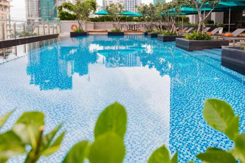 a swimming pool with blue tiles on a building at TUI BLUE Nha Trang in Nha Trang