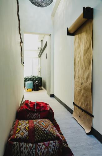 a hallway with a bed in a room at Chloechen Home in Taitung City