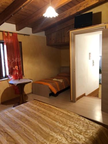 a bedroom with two beds and a door with a window at B&B Melius in Migliuso