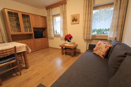 a living room with a couch and a table at Appartamenti Ciasa Molin in Soraga