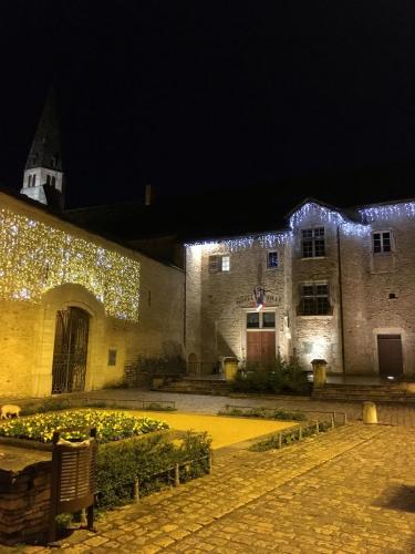 a building with christmas lights on it at night at Villa des Contamines in Crémieu