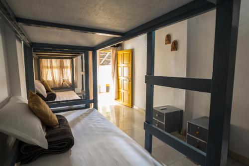 a room with a bunk bed and a door at Craft Hostels in Anjuna