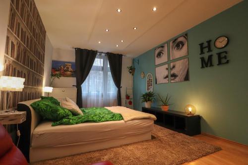 a bedroom with a bed with a green wall at Amina's Apartment in Budapest