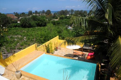 a swimming pool with a view of a resort at Maisha Marefu Apartments in Kiwengwa