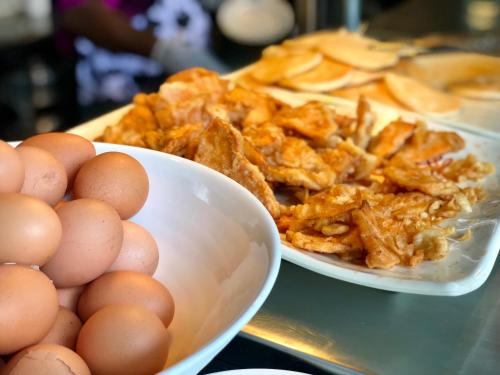 新加坡Siloso Beach Resort - Sentosa的柜台上的一碗鸡蛋和一盘食物