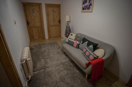 a living room with a couch and a heater at Gościniec i Herbaciarnia Pod Złotą Łyżwą in Białka Tatrzanska