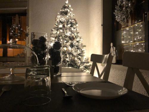 a dining room table with a christmas tree in the background at B&B Il Piccolo Principe room and breakfast in Bieno