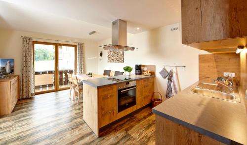 a kitchen with a sink and a counter top at Gästehaus Alpina in Bad Kohlgrub