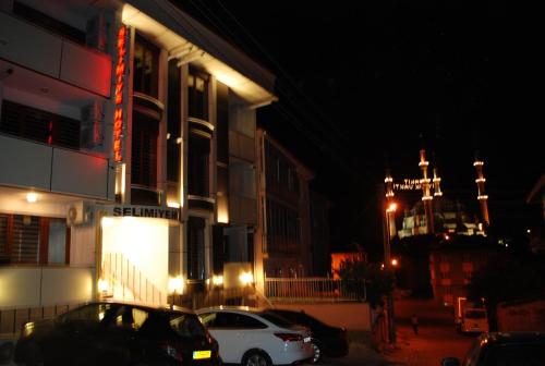 a white car parked in front of a building at night at Selimiye Palace in Edirne