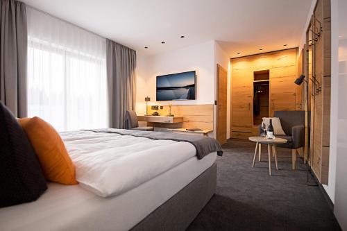 a hotel room with a bed and a living room at Hotel Tannenhaus in Schöneck
