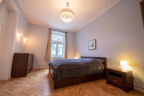 a bedroom with a bed and a window at Victus Apartamenty, Apartament Grande in Sopot