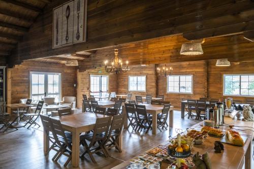 a dining room with wooden walls and tables and chairs at Domaine De La Boulaie in Treize-Vents